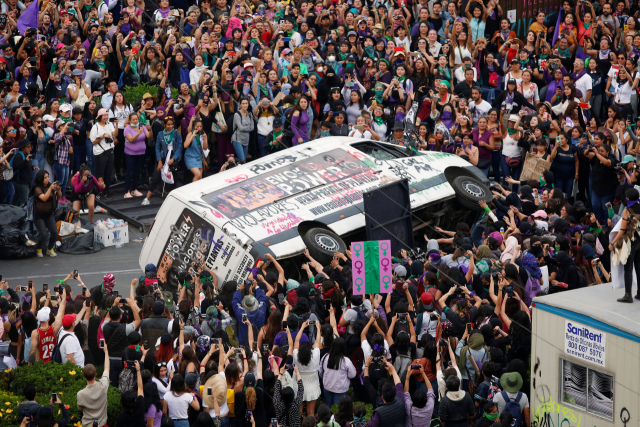 멕시코의 멕시코시티 소칼로 광장에서 여성 시위대들이 차량을 뒤집고 있다. 로이터연합뉴스.