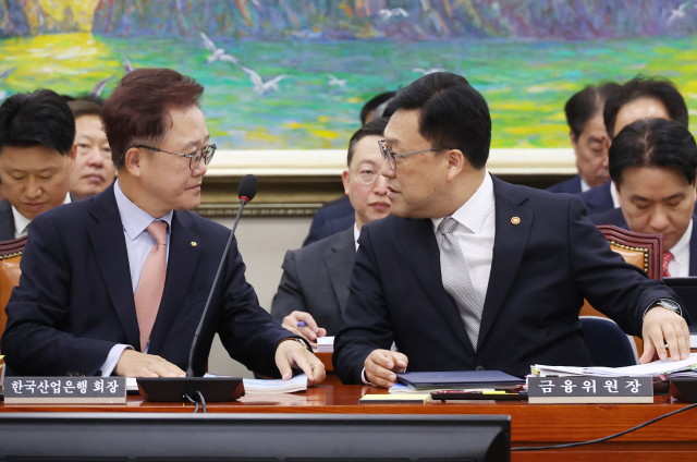 김병환 금융위원장(오른쪽)과 강석훈 산업은행 회장이 10일 국회에서 열린 정무위원회의 금융위원회 등에 대한 국정감사에서 대화하고 있다. 연합뉴스