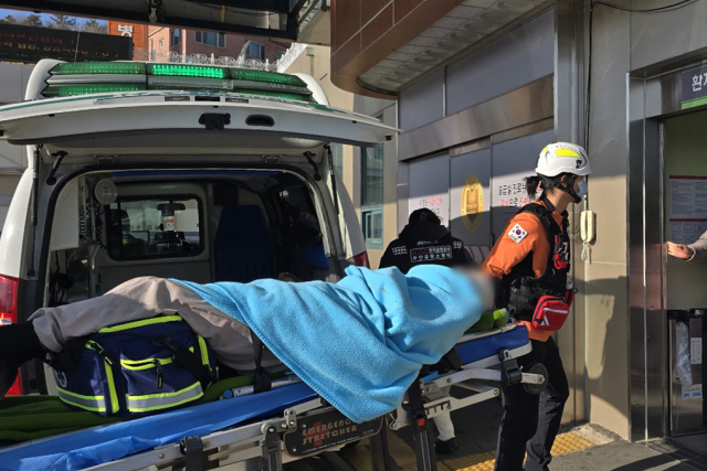 29일 오전 전남 무안국제공항에서 발생한 여객기 사고에서 구조된 승무원이 소방대원들에 의해 목포의 한 병원으로 이송되고 있다. 연합뉴스