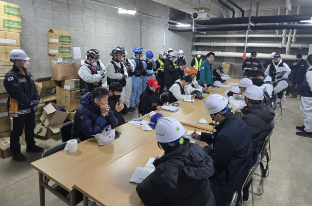 16일 오전 부산 기장군 오시리아 관광단지 오랑대공원 인근의 '반얀트리 해운대 부산' 공사 현장에서 화재 원인 규명을 위한 합동감식팀이 회의를 하고 있다. 지난 14일 오전에 발생한 화재로 작업자 6명이 숨지고, 27명이 연기 흡입 등 경상을 입었다. 연합뉴스