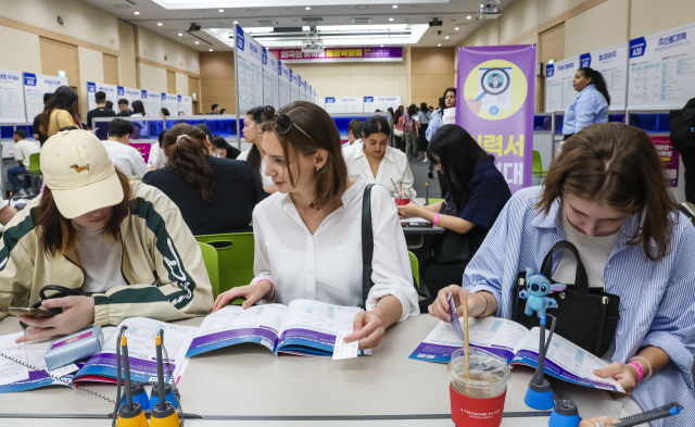 지난해 8월 부산 해운대구 벡스코 제2전시장에서 ‘2025 외국인 유학생 채용박람회’가 열려 외국인 유학생들이 이력서 작성과 채용상담 및 면접을 받고 있다. 김종진 기자 kjj1761@