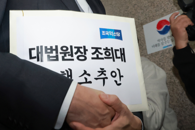 조국혁신당 김준형 원내대표가 21일 국회에서 더불어민주당 한병도 원내대표에게 조희대 대법원장에 대한 탄핵소추안을 전달하기 위해 민주당 원내대표실로 향하고 있다. 연합뉴스